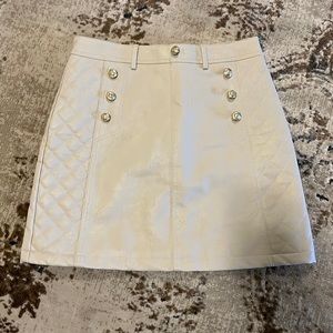 Leather look A-line mini skirt with gold buttons